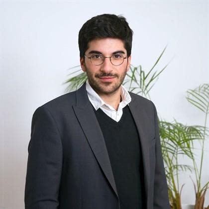 Portrait of Joe in a grey blazer and glasses